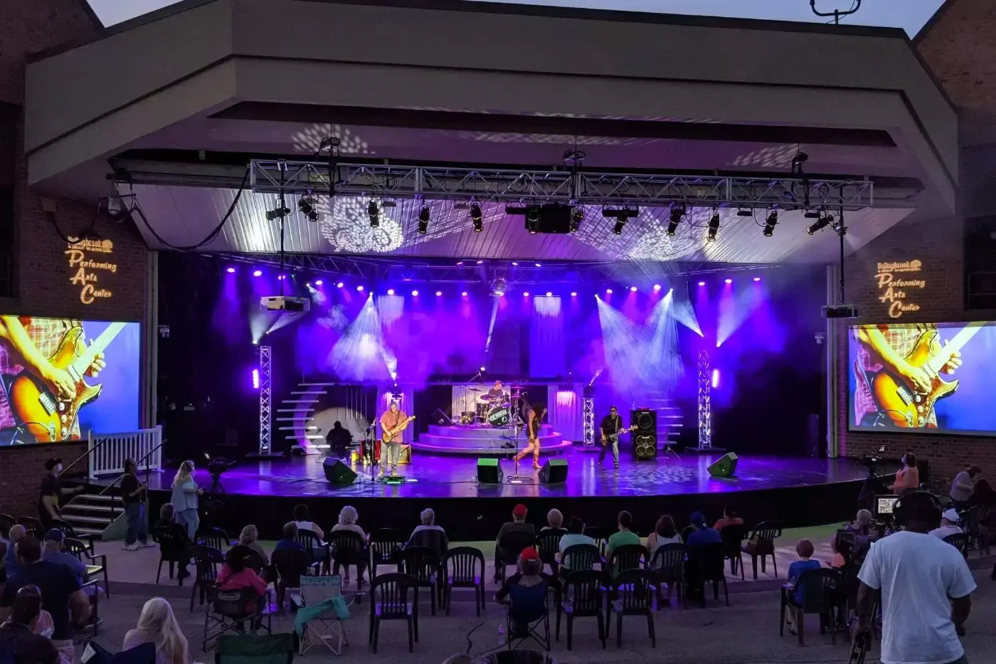 Band performing on stage while crowd watch